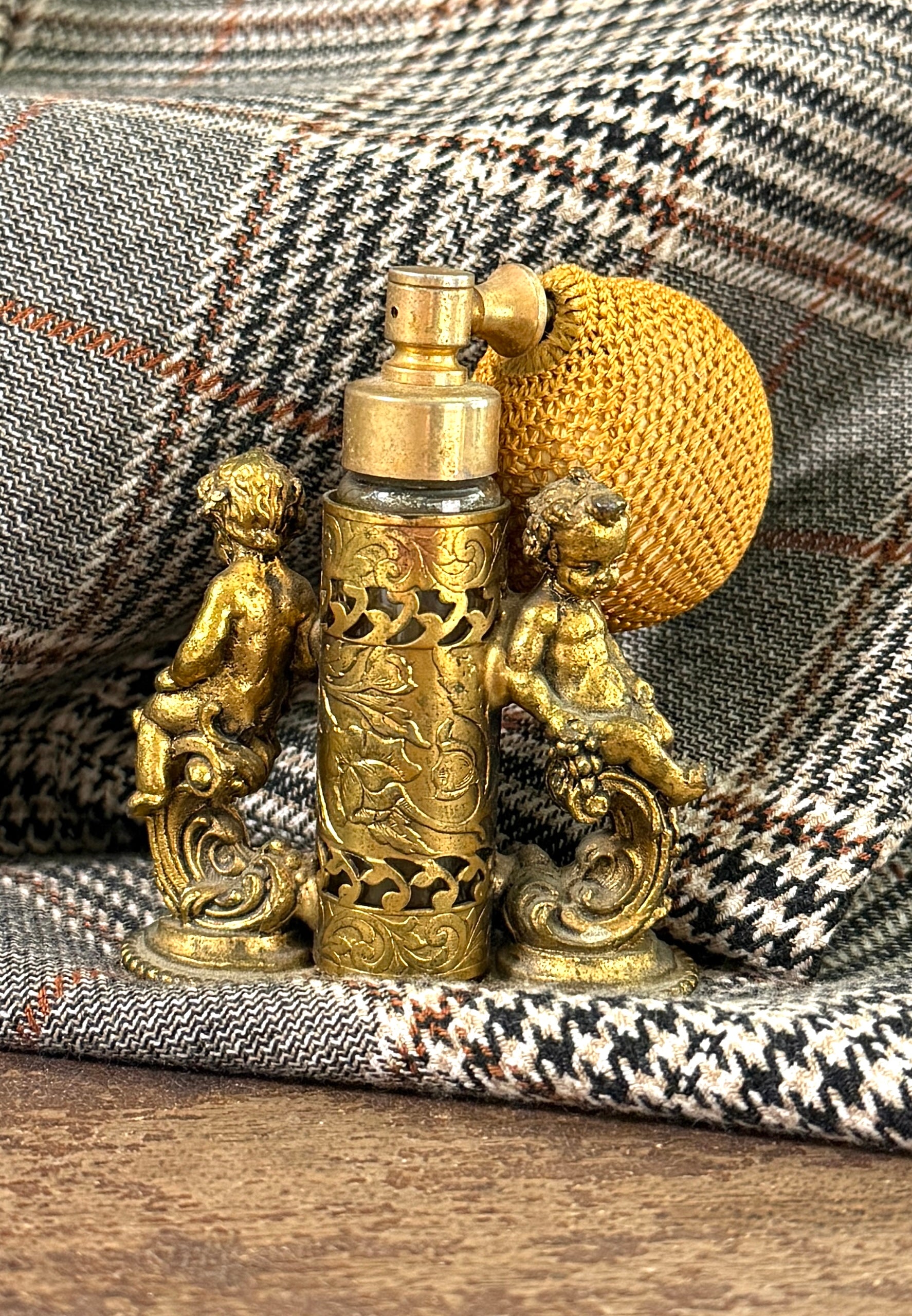 Gold vintage perfume atomizer with twin cherubs